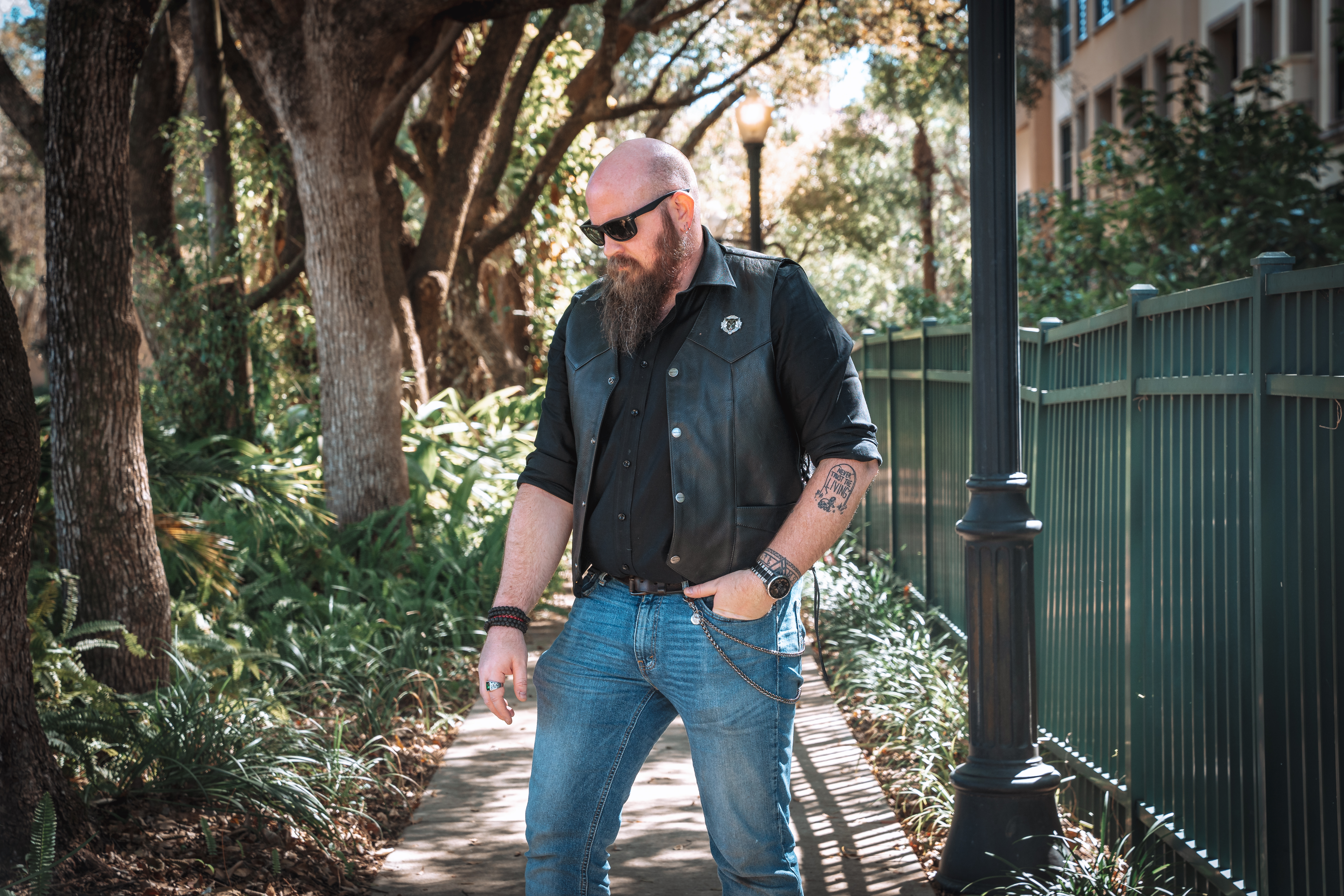 This is a self portrait of photographer Adam Scott, who works in and near both Powder Springs GA, and Atlanta GA. Adam is wearing jeans, a black shirt and a leather vest.